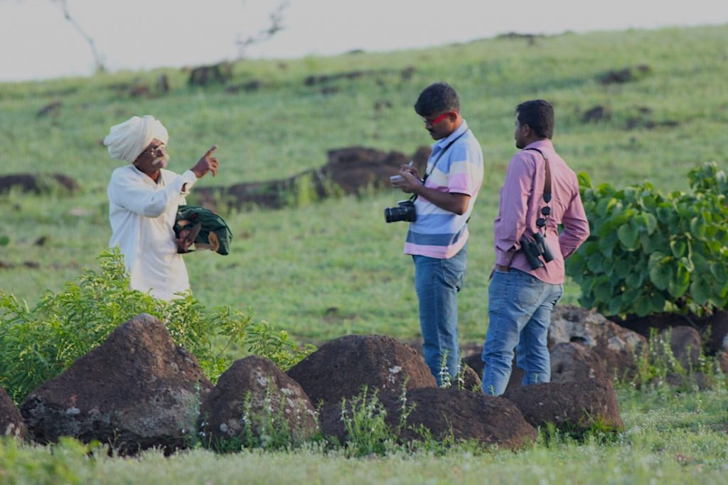 Dr. Sujit Narwade interacting with a farmer from the local community in Maharashtra.
